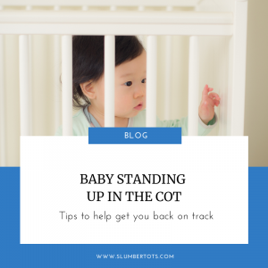 baby standing up in the cot