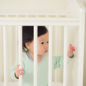 Baby standing up in the cot